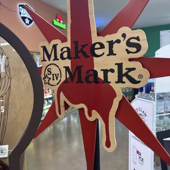 21st Amendment - Nice - A Maker's Mark sign features a wooden background with black text, a star logo, and a red wax drip design, mounted on a star-shaped red background. - Beer, Wine & Spirits Near Me - Carmel, Indiana