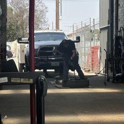 CJ Tire Shop - Employee changing out the tire. From light duty Dodge Ram 5500.