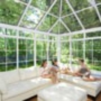 Sun Spaces - two people sitting on a couch in a sunroom - General Contractors Near Me - Kirkland, Washington