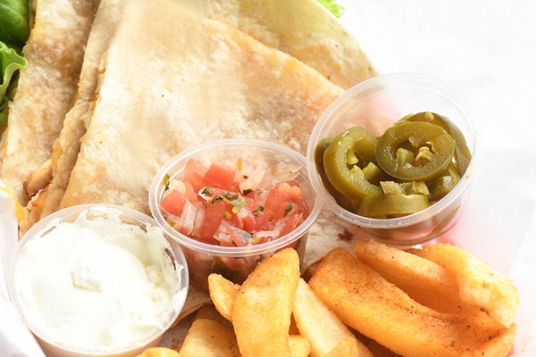 Photo of Home of Chicken and Waffles - Oakland, CA, US. Hector's Quesadilla (Four pieces with chicken and Fries)