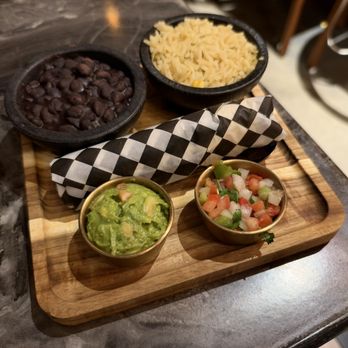 Chelo's - Black beans, rice, guacamole, pico de gallo, and 3 corn tortillas rolled up in the middle, served with the fajita plate - Mexican Near Me - Timnath, Colorado Chelo's - Black beans, rice, guacamole, pico de gallo, and 3 corn tortillas rolled up in the middle, served with the fajita plate - Mexican Near Me - Timnath, Colorado