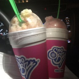 two cups of ice cream with a green straw
