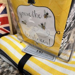 a yellow and white towel with a bee on it