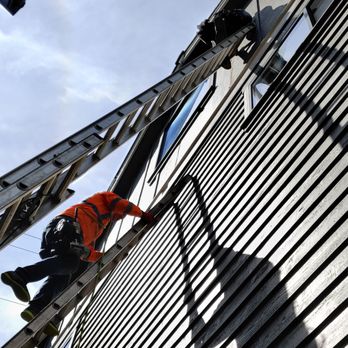 Brisema - Woodpeckers attacked the siding about 30 feet above the driveway. Brisema employees aren't afraid of heights! - Siding Near Me Brisema - Woodpeckers attacked the siding about 30 feet above the driveway. Brisema employees aren't afraid of heights! - Siding Near Me
