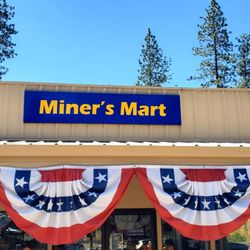 Miners Mart - Miner's Mart storefront with decorations for 4th of July.