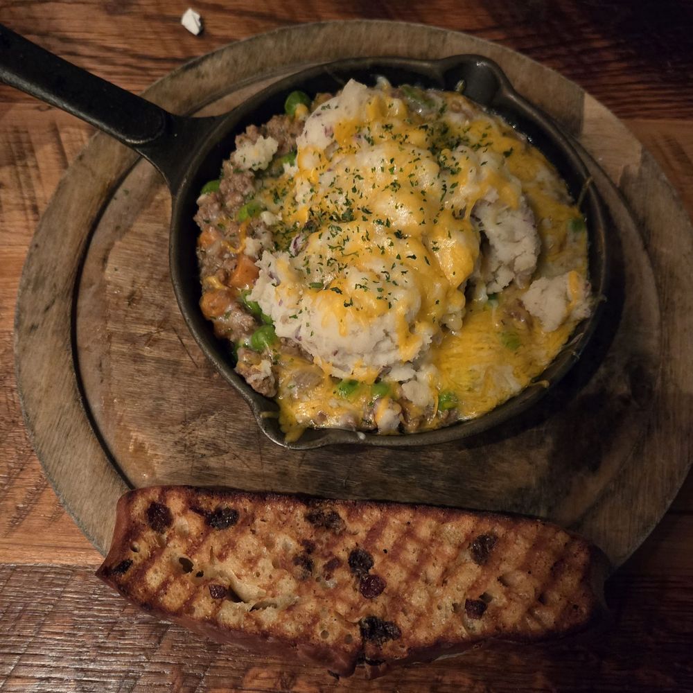 Shepherd's pie. Served in a hot skillet with a side of grilled Irish bread.