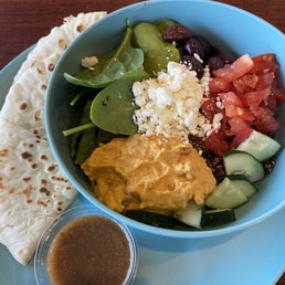 a bowl of salad and pita chips a bowl of salad and pita chips