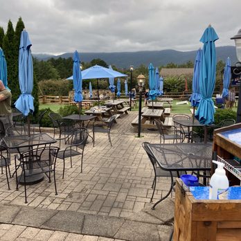 Blue Mountain Brewery - outdoor seating area with tables and umbrellas - Brewpubs Near Me - Afton, Virginia