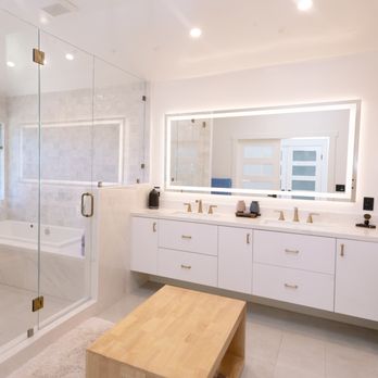 Tuhome Construction - a large bathroom with a walk in shower - General Contractors Near Me