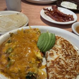 Omelet with broccoli, spinach and tomato topped with avocado and green chili. Side of bacon and corn tortillas. Omelet with broccoli, spinach and tomato topped with avocado and green chili. Side of bacon and corn tortillas.