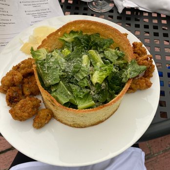 The Palmetto Cafe - Caesar salad with fried oysters served in a crispy bread wrapped down - New American Near Me - Charleston, South Carolina