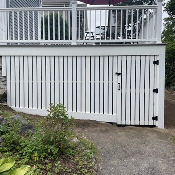 A.N.B Construction - a white fence with a red umbrella - General Contractors Near Me