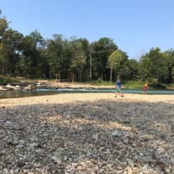 Siloam Springs Kayak Park - Rocky area next to water.