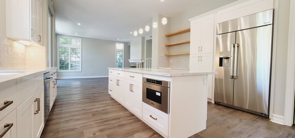 Kitchen And bathroom - The kitchen cabinets, in this case, are specially designed with open wood-grain laminates near the central passage to reduce the oppressive feeling that the whole room is full of cabinets
The floor has three different height differences, and the same wooden floor is used to cover the entire floor
Can increase the integrity of the entire space
White transparent glass bricks are used for the kitchen's back wall to increase cleanliness and brightness.
The kitchen cabinet in the wine cabinet area also adopts available laminates, and the doors are made of glass, which increases the sense of transparency and echoes with the wine cabinet. The back wall uses geometric bricks to improve the liveliness of this area.
The size of the central island is extended to align with the kitchen cabinets. In addition to increasing the use of countertop space, it also shows the openness and largeness of the kitchen. Five pendant lights are hanging above, lighting up and decorating the entire kitchen Kitchen And bathroom - The kitchen cabinets, in this case, are specially designed with open wood-grain laminates near the central passage to reduce the oppressive feeling that the whole room is full of cabinets
The floor has three different height differences, and the same wooden floor is used to cover the entire floor
Can increase the integrity of the entire space
White transparent glass bricks are used for the kitchen's back wall to increase cleanliness and brightness.
The kitchen cabinet in the wine cabinet area also adopts available laminates, and the doors are made of glass, which increases the sense of transparency and echoes with the wine cabinet. The back wall uses geometric bricks to improve the liveliness of this area.
The size of the central island is extended to align with the kitchen cabinets. In addition to increasing the use of countertop space, it also shows the openness and largeness of the kitchen. Five pendant lights are hanging above, lighting up and decorating the entire kitchen