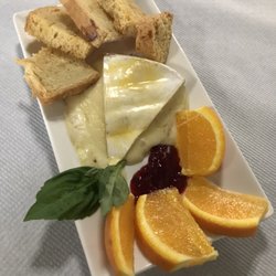 The Clinton Inn Restaurant - Baked Brie served with raspberry preserves, orange slices, and toasted crustinis