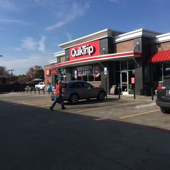 QuikTrip - a man walking in front of a fast food restaurant - Gas Stations Near Me - Dallas, Texas