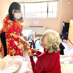 Mission De La Casa Nursing & Rehabilitation Center - Vietnamese New Year 2021. Activity Director passing out lucky envelopes to our residents.