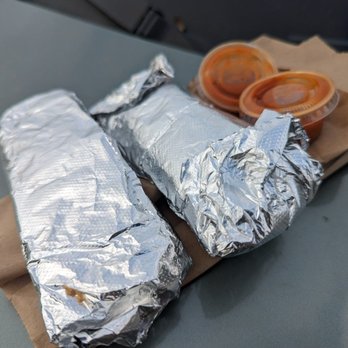 Taqueria El Charro - two burritos wrapped in aluminum foil - Mexican Near Me - San Antonio, Texas Taqueria El Charro - two burritos wrapped in aluminum foil - Mexican Near Me - San Antonio, Texas
