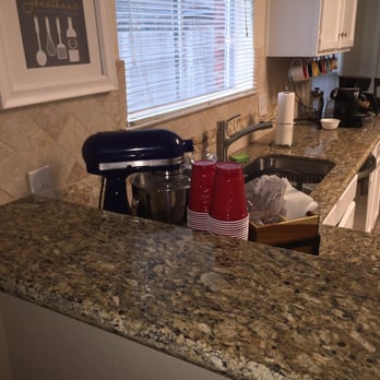Grand Stone - Venetian Gold granite with a 4 inch tumbled travertine backsplash. - Countertop Installation Near Me - Houston, Texas
