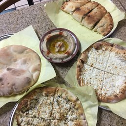 Hummus and bread, zaatar & cheese, cheese pizza and a cheese calzone with mushrooms & spinach. Hummus and bread, zaatar & cheese, cheese pizza and a cheese calzone with mushrooms & spinach.