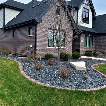 Border Magic - a brick house with a black roof - Landscaping Near Me - Frankfort, Illinois Border Magic - a brick house with a black roof - Landscaping Near Me - Frankfort, Illinois