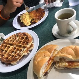 Corn beef hash scrambled eggs home fries waffle bacon egg and cheese on a roll. Tea.