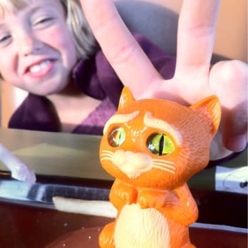 McDonald's - a little girl holding up a toy cat - Fast Food Near Me - Anchorage, Alaska