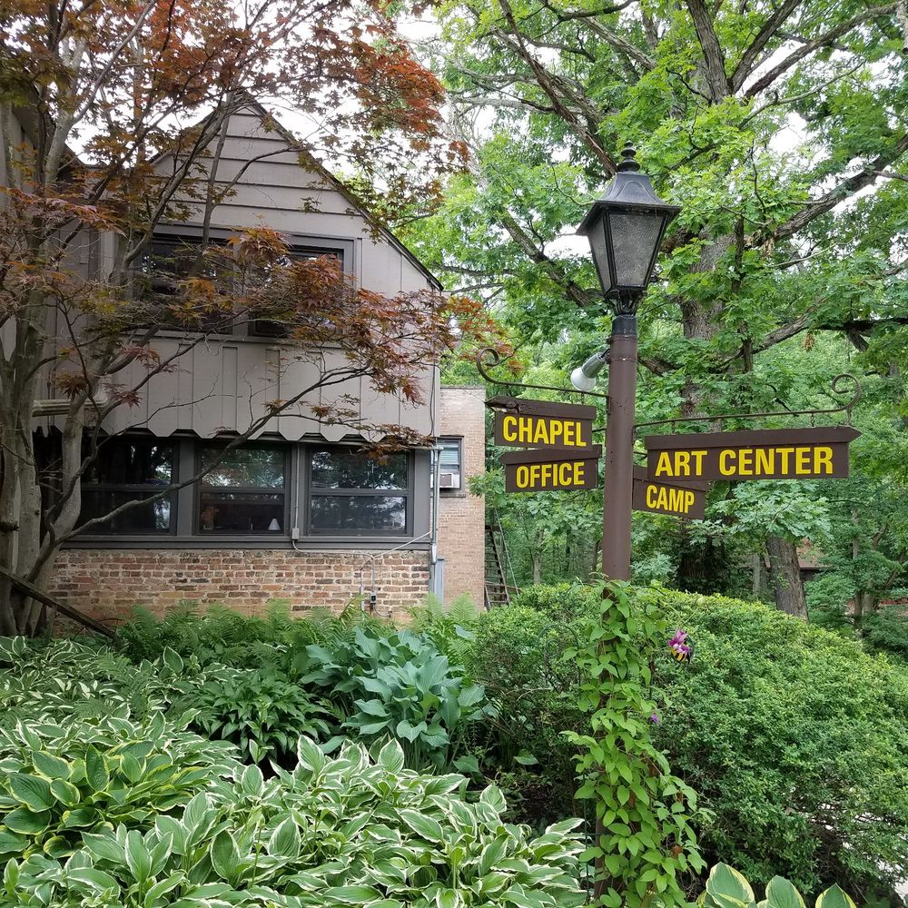Main building on left and directions on the post