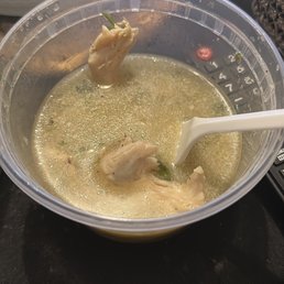 a bowl of soup with a spoon in it a bowl of soup with a spoon in it