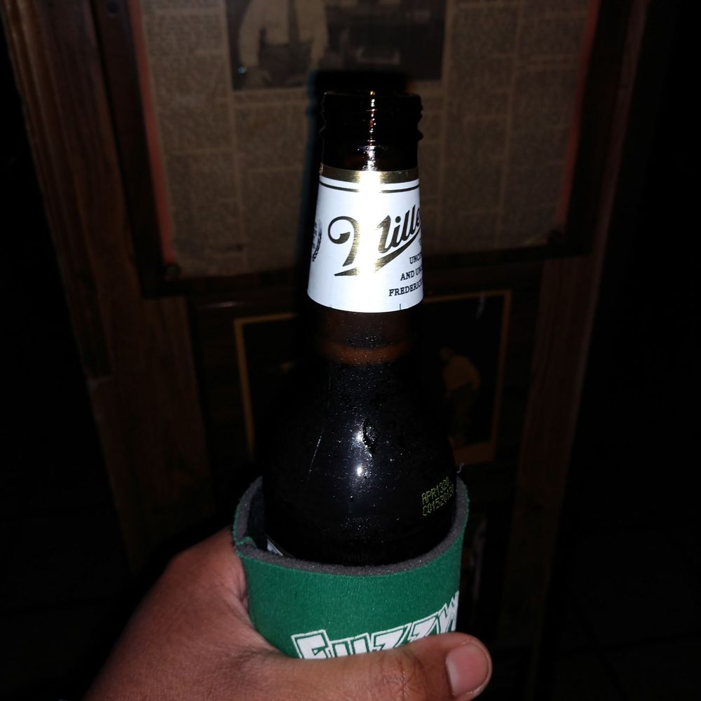 End Zone - a person holding a bottle of beer - Bars Near Me - Chicago, Illinois End Zone - a person holding a bottle of beer - Bars Near Me - Chicago, Illinois