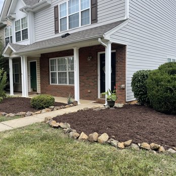 The Yard Crew - the front of a house with mulch and landscaping - Lawn Services Near Me The Yard Crew - the front of a house with mulch and landscaping - Lawn Services Near Me
