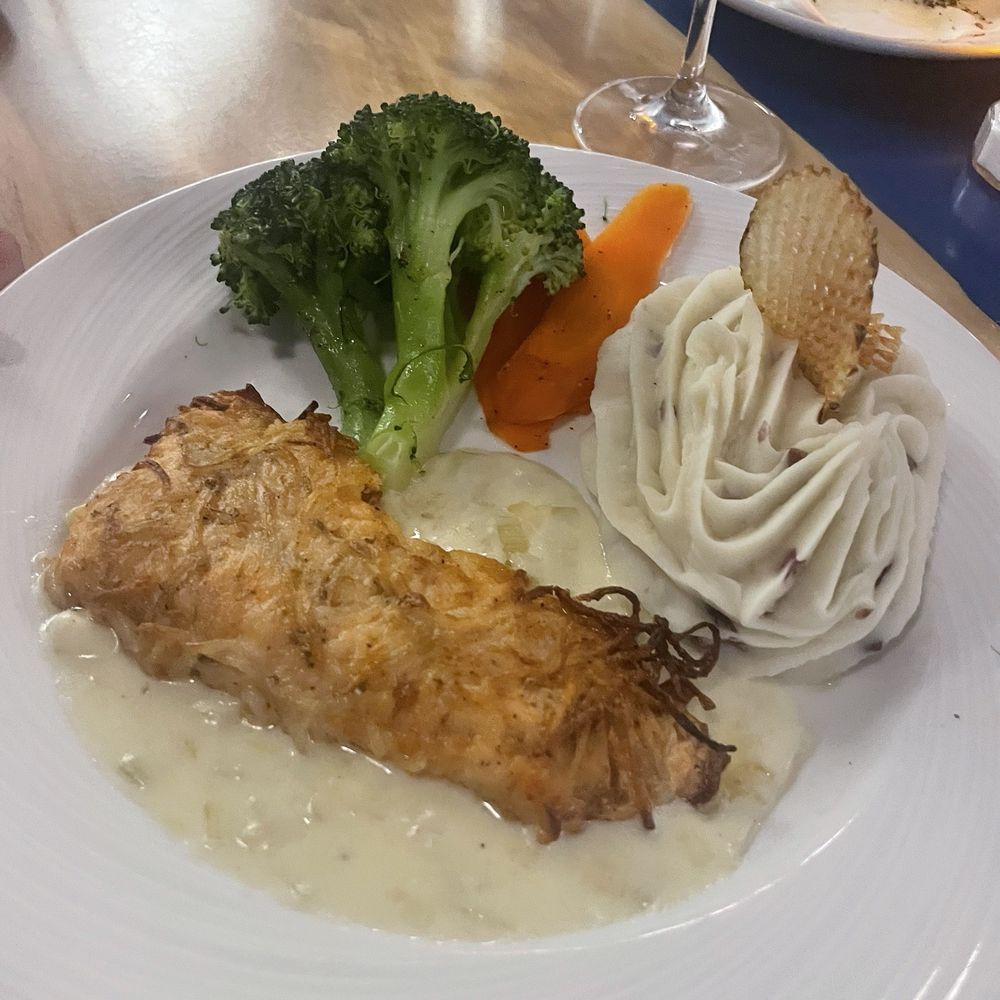 Guppys on the Beach - Potato crusted salmon in Alfredo ( this was on every bird menu ... but is also on the main dinner menu ) - Seafood Near Me - Indian Rocks Beach, Florida Guppys on the Beach - Potato crusted salmon in Alfredo ( this was on every bird menu ... but is also on the main dinner menu ) - Seafood Near Me - Indian Rocks Beach, Florida