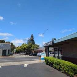 Donut shop sits on a busy street, at the corner