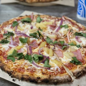 On Fire Pizza - #buildyourownpizza Canadian bacon, pineapple, purple onions & fresh cilantro to finish after cooking - Pizza Near Me - Upland, California