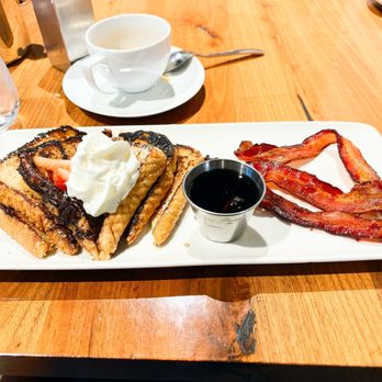 The Westin Jackson - French toast topped with whipped cream, blueberries, & strawberries.  Comes with three slices of bacon. - Hotels Near Me - Jackson, Mississippi