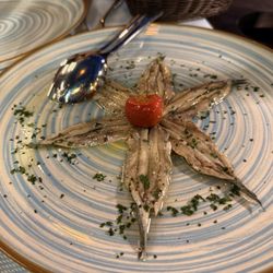 Osteria La Tana Dei Pescatori - Marinated anchovies- In extra virgin olive oil, garlic and parsley. - Put this on your bread- or don't. Either way it's delicious!