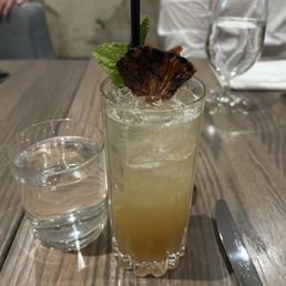 a glass of water and a drink on a table