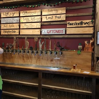 Trail Point Brewing Company - a woman standing in front of a bar - Breweries Near Me - Allendale, Michigan
