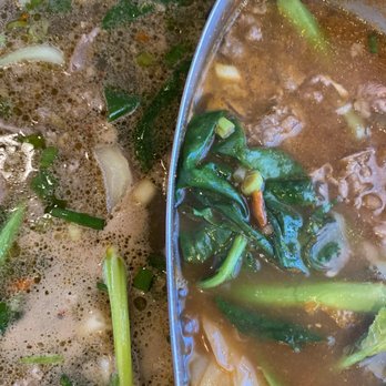 Zu Hot Pot - Pot # 1 - A hot pot with two sections contains vegetables and broth, featuring leafy greens and other ingredients, used for Chinese hot pot dining. - Hot Pot Near Me - Albuquerque, New Mexico