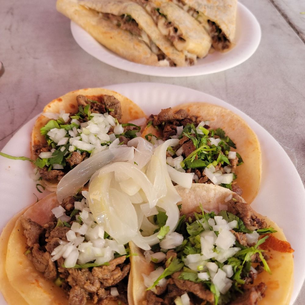 Asada quesodilla and Asada Tacos with onions and cilantro.