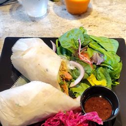 Chicken satay wrap. Thai ice tea(half drank). In the back is Javanese bfast.