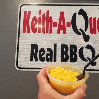 Keith-A-Que - ows a hand holding a bowl of macaroni and cheese - Barbeque Near Me - Ashburn, Georgia