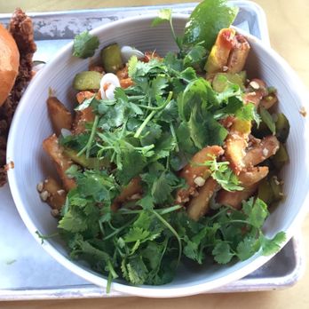 Basilisk - DanDan Fries ($8) tossed in peanut sauce, chili oil, crushed peanuts, chopped pickles, and cilantro - New American Near Me - Portland, Oregon