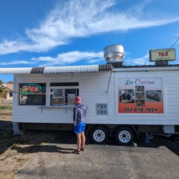 a man standing in front of a food truck