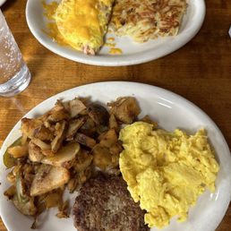 Ham and cheese hearty omelette with hash browns and a 2-egg breakfast with homemade sausage and home fries. Ham and cheese hearty omelette with hash browns and a 2-egg breakfast with homemade sausage and home fries.