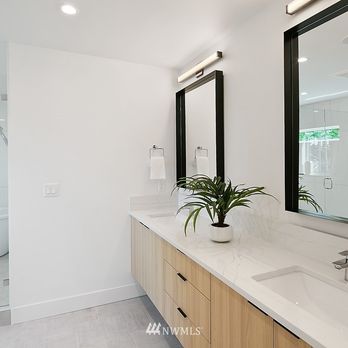 StoneWorld Seattle - a bathroom with two sinks and a large mirror - Building Supplies Near Me - Seattle, Washington