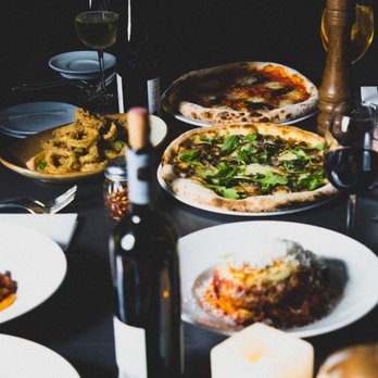 Baci Ristorante - a table full of food and wine - Italian Near Me - Hamilton, Ontario