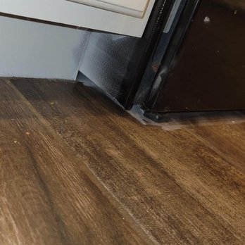 Quality Designs Painting - Overspray on oven and underspray on cabinet base - Painters Near Me - Palm Bay, Florida