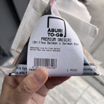 Aburi To Go - a hand holding a bag of salt - Sushi Bars Near Me - Vancouver, British Columbia