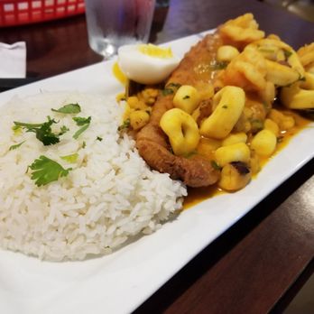 Machu Picchu - PESCADO A LO MACHO Fried white fish topped with seafood with a side of white rice - Peruvian Near Me - Pineville, North Carolina Machu Picchu - PESCADO A LO MACHO Fried white fish topped with seafood with a side of white rice - Peruvian Near Me - Pineville, North Carolina
